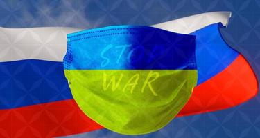 stoppt den krieg ukraine und russland, flagge russland und maske mit farben ukraine. foto