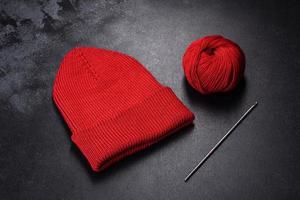 Roter warmer Damenstrickhut auf konkretem Hintergrund foto