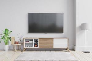tv auf dem schrank im modernen wohnzimmer mit pflanze auf weißem wandhintergrund. foto