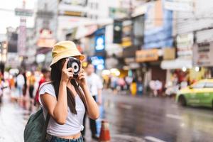 asiatische reisende frau mit kamera in chinatown. foto