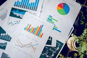 ein Schreibtisch mit Business-Notizbuch, Diagramm und Tischplatte. draufsicht mit kopierraum foto