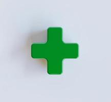 Grünes Pluszeichen auf weißem Hintergrund für Symbol der Krankenhaus- oder Versicherungsgesundheitsversorgung und positives Denkkonzept durch 3D-Rendering. foto