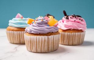 köstliche hausgemachte Cupcakes mit bunter Sahne und Topping mit Süßigkeiten und Schokoladenkeksen. hausgemachtes Herbstferiendessert foto