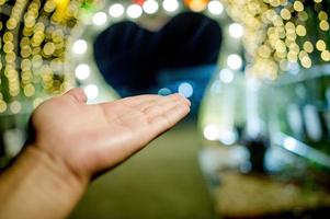 hände und bunte lichter am neujahrstag, bokeh-kreislichter, hintergrundbild mit kopienraum. foto