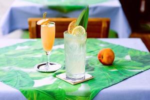 Limonade und Bellini-Cocktail stehen auf dem Tisch auf der Terrasse der Bar im Freien in der Innenstadt foto