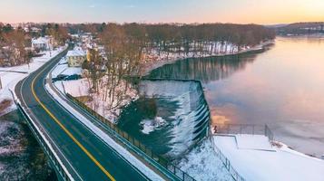 die Straße zum Teich mit einem seitlich fließenden Wasserstrahl foto