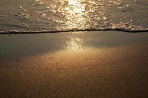 Strandsandwelle des tropischen Klimas im Sonnenaufgang foto