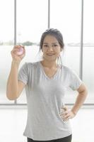 asiatische frau nahaufnahme spielen übungsgeräte, gummiball, hand quetschen im fitnessstudio. foto