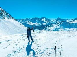 snowboarder steht am rand der klippe in den österreichischen alpen foto