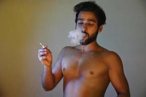Mann raucht mit Zigarette foto