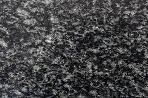 Textur und Hintergrund aus schwarzen Granitfliesen. Natursteingrauer Granithintergrund. Helle, harte, graue Granitfelsenstruktur. grauer Granitsteinhintergrund. foto