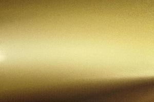 Licht auf rauer Goldmetallwand, abstrakter Texturhintergrund foto