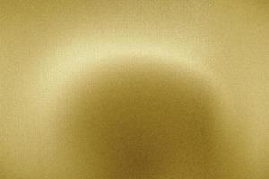Licht auf gebürstetem Goldmetallblech, abstrakter Texturhintergrund foto