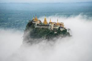 spektakulärer Blick auf den Mount Popa über den Wolken. mt.popa ist die Heimat von Nat, dem Geist der birmanischen Mythologie. Dieser Ort ist der alte Vulkan in Myanmar. foto