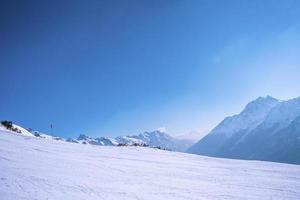 Malerischer Blick auf schneebedeckte Berge gegen den strahlend blauen Himmel foto