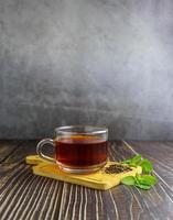 Tee in Glasschale auf Holzhintergrund foto