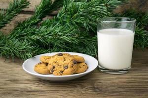 Kekse und ein Glas Milch mit einer weißen Note für Santa foto