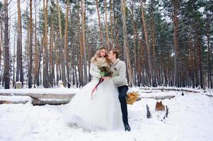 schönes Hochzeitspaar auf ihrer Winterhochzeit foto