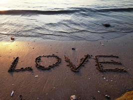 Strand Meerwasser am Strand auf Sand geschrieben, Liebe foto