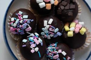 Schokokugeln mit farbigem Zucker bestreut, süße Kuchen. foto