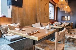Tisch und Stühle im klassischen Stil im beleuchteten Restaurant im luxuriösen Resort foto