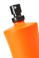 orangefarbene kleine Flasche mit einer Parfümflüssigkeit foto