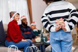 afroamerikanische familie überraschte am weihnachtstag mit einem geschenk. frohe Weihnachten. foto