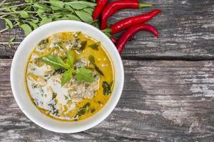 grünes Curry des thailändischen Huhns mit altem hölzernem Hintergrund foto