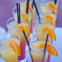 Reihe von verschiedenfarbigen Alkoholcocktails auf einer Open-Air-Party