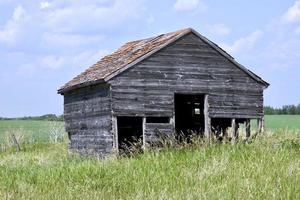 ein verlassenes Wirtschaftsgebäude in einem Feld foto