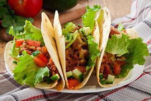 mexikanische Tacos mit Fleisch, Gemüse und Käse foto