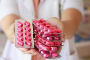 Nahaufnahme von weiblichen Arzthänden, die Pillen halten foto