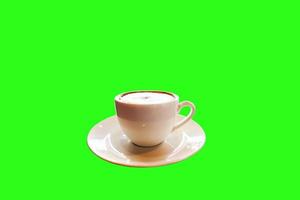 Nahaufnahmecappuccinokaffee auf grünem Hintergrund. foto