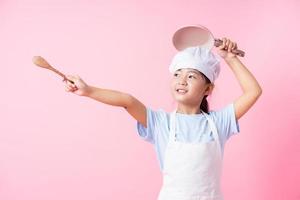 Bild eines asiatischen Kindes, das übt, ein Koch zu sein foto