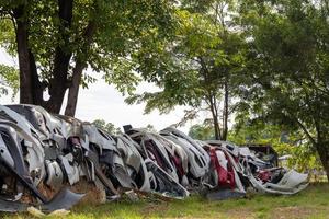 Viele Autostoßstangen in der Nähe von ländlichen Bäumen. foto