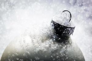 Weihnachtsglaskugel auf Schnee, Winterhintergrund foto