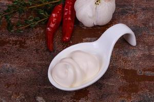 Mayonnaise-Sauce in der weißen Schüssel serviert Thymian und Knoblauch foto