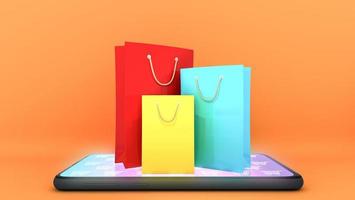 Bunte Papiereinkaufstüten auf dem Handy mit orangefarbenem Hintergrund., Online-Shopping oder Shopaholic-Konzept, 3D-Rendering. foto