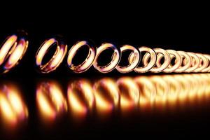 3D-Darstellung goldener Torusse in geraden Reihen auf einfarbigem Hintergrund. Muster mit den gleichen Perlen. foto