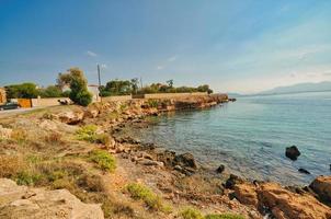 beliebter Leuchtturmstrand mit türkisfarbenem Meer auf der Insel Ägina, Griechenland foto