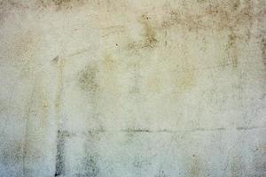 Textur einer Betonwand mit Rissen und Kratzern, die als Hintergrund verwendet werden kann foto