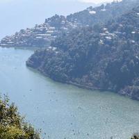 volle ansicht des naini-sees während der abendzeit nahe der einkaufsstraße in nainital, uttarakhand, indien, schöne ansicht des nainital-sees mit bergen und blauem himmel foto