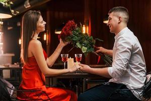 Seitenansicht. Romantisches Paar isst im Restaurant zu Abend foto