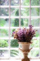 Vase mit getrockneten Blumen am Fenster.weicher Fokus.Vintage-Stil. foto