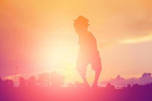 Kindersilhouette, Momente der Freude des Kindes. auf dem natursonnenuntergang foto