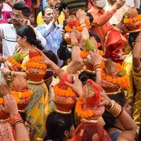 neu delhi, indien 03. april 2022 - frauen mit kalash auf dem kopf während des jagannath-tempels mangal kalash yatra, indische hindu-anhänger tragen irdene töpfe mit heiligem wasser mit einer kokosnuss darauf foto