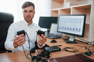 kaukasische Ethnizität. Der Lügendetektor arbeitet im Büro mit der Ausrüstung seines Lügendetektors foto