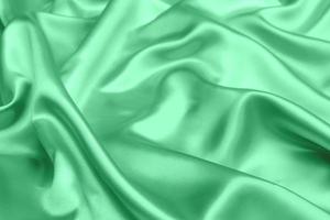 grüner satin stoff textur weicher unschärfe hintergrund foto