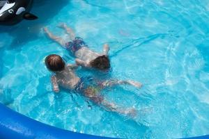 jungen schwimmen unter wasser mit brille im pool foto