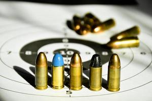 9-mm-Kugeln und 9-mm-Kugelgehäuse auf Zielpapier, weicher und selektiver Fokus foto